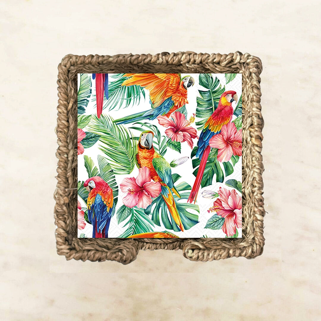 Tropical paper napkin with parrots, flowers, and leaves on a white background