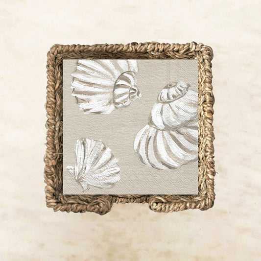 Neutral cocktail napkin featuring hand-painted white seashells on a soft sandy beige background, perfect for coastal parties, beach house entertaining, and seaside events.