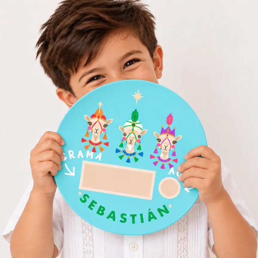 Young boy holding a personalized turquoise Three Kings Day melamine plate with his name, Sebastián, celebrating Puerto Rico's Día de Reyes tradition.