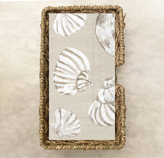 Neutral-toned guest towel napkin with elegant white seashell illustrations on a soft beige background, ideal for beach weddings, coastal parties, or nautical-themed events.