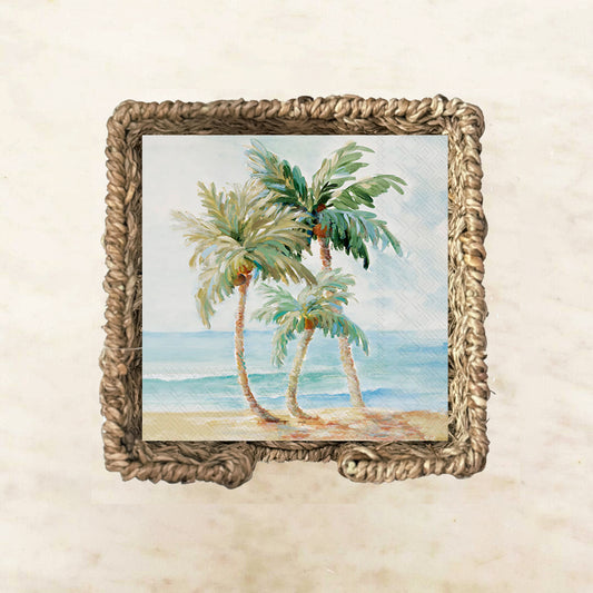 Tropical-themed cocktail napkin featuring three palm trees swaying by the ocean with blue waves and a sandy beach, perfect for coastal parties or summer entertaining.

