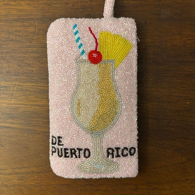 Piña Colada de Puerto Rico pink beaded wristlet purse with cocktail design, handmade Boricua beaded bag next to real piña colada drink