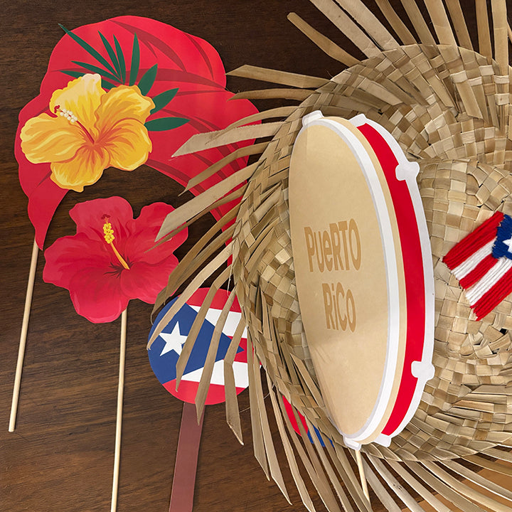 Decorative items including a straw hat, flowers, and a Puerto Rican flag on a wooden surface.