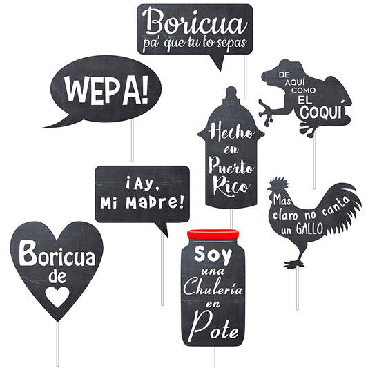 “Set of Puerto Rican-themed photo booth props with popular phrases in Spanish, including ‘Boricua pa’ que tú lo sepas,’ ‘Wepa!,’ ‘¡Ay, Mi Madre!,’ ‘De aquí como el coquí,’ ‘Hecho en Puerto Rico,’ ‘Más claro no canta un gallo,’ ‘Boricua de corazón,’ and ‘Soy una chulería en pote.’ Props are shaped like speech bubbles, a heart, a coquí frog, a rooster, garita and a jar, all designed in chalkboard style.”
