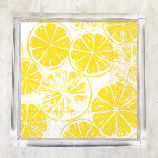 Yellow lemon slice paper napkin on white background, citrus-themed summer decor